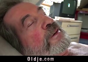 Brunette licking all over a guy's hard cock on camera