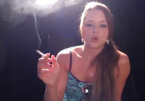 Smoking hottie MILF is talking and posing in the studio